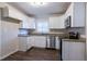 Renovated kitchen with white cabinets, granite counters, and stainless appliances at 2775 Tilson Rd, Decatur, GA 30032