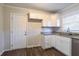 Kitchen features white cabinets, granite countertops, and access to backyard at 2775 Tilson Rd, Decatur, GA 30032