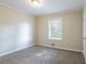 Bedroom with wood accent wall, window, and carpet flooring at 2775 Tilson Rd, Decatur, GA 30032