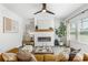 Living room featuring a fireplace, ceiling fan, and plenty of natural light at 3321 Pepperpike Ct, Loganville, GA 30052