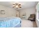 Bedroom with window, ceiling fan and gray chair at 5860 Bluff Heights Dr, Cumming, GA 30040