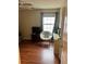 Well-lit bedroom with hardwood floors and a comfy chair at 165 Summit Point Dr, Fayetteville, GA 30214