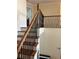 Elegant staircase with wood railing and iron spindles at 165 Summit Point Dr, Fayetteville, GA 30214