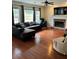 Spacious living room featuring hardwood floors, a fireplace, and large windows at 165 Summit Point Dr, Fayetteville, GA 30214