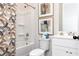 Clean bathroom with white vanity, tub shower combination, and stylish patterned shower curtain at 320 Lavender Ln, Holly Springs, GA 30115