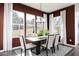 Sunlit dining area showcasing a modern table and chairs, offering ample natural light at 320 Lavender Ln, Holly Springs, GA 30115