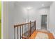 Upstairs hallway with wood floors and railing at 4280 Kingston Gate Cv, Chamblee, GA 30341