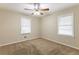 Spacious bedroom with neutral carpeting and ceiling fan at 6168 Ellis St, Douglasville, GA 30134