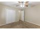 Spacious bedroom with neutral carpeting and ceiling fan at 6168 Ellis St, Douglasville, GA 30134