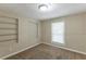 Cozy bedroom featuring built-in shelving and window at 6168 Ellis St, Douglasville, GA 30134