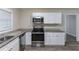 Updated kitchen with stainless steel appliances and granite countertops at 6168 Ellis St, Douglasville, GA 30134