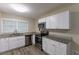 Modern kitchen with white cabinets, granite countertops, and stainless steel appliances at 6168 Ellis St, Douglasville, GA 30134