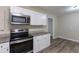 Modern kitchen with stainless steel appliances and granite countertops at 6168 Ellis St, Douglasville, GA 30134