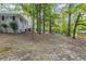 Side yard of house exterior with large trees at 6168 Ellis St, Douglasville, GA 30134