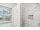 Bathroom with shower, window, and marble tile at 1618 Belmont Sw Ave, Atlanta, GA 30310