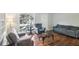 Living room with hardwood floors, comfy seating, and a large window at 1618 Belmont Sw Ave, Atlanta, GA 30310
