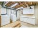 Clean, finished basement laundry room with cabinets and storage at 1996 Walton Woods Cir, Tucker, GA 30084