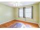 Well lit bedroom with hardwood floors and area rug at 1996 Walton Woods Cir, Tucker, GA 30084