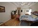 Spacious main bedroom with hardwood floors, a large bed, and a TV at 1025 Copper Creek Dr, Canton, GA 30114