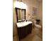 Well-lit bathroom with vanity, toilet, and tiled floor at 1025 Copper Creek Dr, Canton, GA 30114