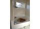 Bathroom with a large garden tub and a window at 1025 Copper Creek Dr, Canton, GA 30114