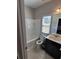 Clean bathroom with white tub, toilet, vanity, and window at 368 Sawyer Meadow Way, Grayson, GA 30017