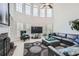 Living room with a sectional sofa, fireplace and large windows at 2286 Noelle Pl, Powder Springs, GA 30127