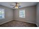 Bedroom with ceiling fan, carpet, and two windows at 2308 Sheryl Dr, Decatur, GA 30032