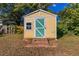 Yellow storage shed with green door in backyard at 2308 Sheryl Dr, Decatur, GA 30032