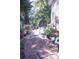 Brick pathway meanders through a lush backyard garden, leading to a charming seating area at 1563 Poplarwood Nw Ln, Lawrenceville, GA 30043