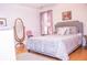 Bedroom with a gray upholstered bed and a mirrored dresser at 1563 Poplarwood Nw Ln, Lawrenceville, GA 30043