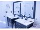 Double vanity bathroom with dark cabinets and a large mirror at 1563 Poplarwood Nw Ln, Lawrenceville, GA 30043