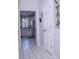 Hallway with tile floor, white doors, and kitchen view at 1563 Poplarwood Nw Ln, Lawrenceville, GA 30043