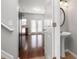 Bright entryway with hardwood floors, powder room, and view into living area at 3034 Liberty Nw Way, Atlanta, GA 30318