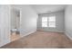 Simple bedroom with carpeted floor and ensuite bathroom at 3034 Liberty Nw Way, Atlanta, GA 30318