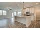 Open concept kitchen featuring white cabinets, granite countertops, and stainless steel appliances at 12 Depot Landing Way # 77A, Auburn, GA 30011