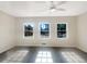 Bright and airy bedroom with hardwood floors and three windows at 1027 Strawberry Ln, Ellenwood, GA 30294