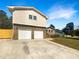 Two-car garage and front yard landscaping at 1027 Strawberry Ln, Ellenwood, GA 30294