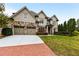 Brick walkway leading to a two-story house with a three car garage at 105 Windsor Cv, Atlanta, GA 30328