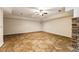 Large finished basement with flagstone floors and ceiling fan at 105 Windsor Cv, Atlanta, GA 30328