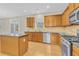 Kitchen with island, stainless steel appliances, and wood cabinets at 5401 Stone Cove Sw Dr, Atlanta, GA 30331