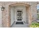 Elegant front door entry with brick columns and a welcoming mat at 5401 Stone Cove Sw Dr, Atlanta, GA 30331