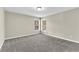 Well-lit bedroom with grey carpet and two windows at 5401 Stone Cove Sw Dr, Atlanta, GA 30331