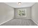 Bright bedroom featuring grey carpet and a window at 5401 Stone Cove Sw Dr, Atlanta, GA 30331
