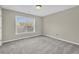 Bedroom with neutral walls, carpet, and large window at 5401 Stone Cove Sw Dr, Atlanta, GA 30331