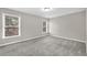 Bright bedroom featuring grey carpet and two windows at 5401 Stone Cove Sw Dr, Atlanta, GA 30331