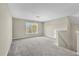 Spacious loft area with grey carpeting and window at 5401 Stone Cove Sw Dr, Atlanta, GA 30331