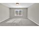 Spacious bedroom with grey carpet and large window at 5401 Stone Cove Sw Dr, Atlanta, GA 30331