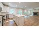 Open concept kitchen and living room with hardwood floors and fireplace at 134 Henley St, Canton, GA 30114