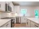 Modern kitchen with stainless steel appliances and white cabinets at 134 Henley St, Canton, GA 30114